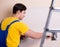 Young contractor employee applying plaster on wall