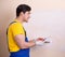 Young contractor employee applying plaster on wall