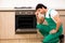 The young contractor repairing oven in kitchen