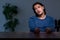 Young convict man sitting in dark room