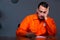 Young convict man sitting in dark room