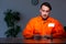 Young convict man sitting in dark room