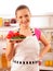 Young cook smiling with fresh vegetables