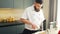 Young cooks salmon fish with a gas burner in a modern kitchen. The man prepares food at home. Cooking healthy food.