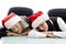 Young corporate wearing christmas hat and sleeping