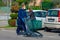 A young coucasian male with white face mask strolling in parking lot with shopping cart. Buying groceries in pandemic in Italy