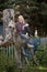 Young country girl sitting on large old stump