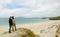 Young couple admiring a remote landscape with white sand beach