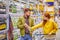 young couple in alcohol department in supermarket, arguing