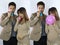 Young couple announcing their baby while blowing balloons