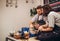 Young couple in apron at artwork in pottery