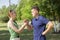 Young couple arguing while sitting on bench in park. Problems in relationship