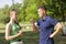 Young couple arguing while sitting on bench in park. Problems in relationship