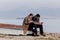 Young couple on the beach with phones