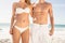 Young couple in beachwear embracing