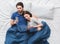 Young couple in bed top view morning concept browsing smartphones