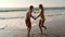 Young couple being goofy and having fun at beach dancing