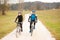 Young couple biking on an autumn afternoon in nature