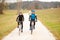 Young couple biking on an autumn afternoon in nature