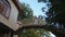 Young couple blond man and brunette woman stand together on architectural beautiful bridge