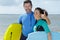 young couple bodyboard surfers looking at camera