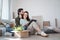 Young couple with boxes moving in new flat, new home and relocation concept.