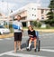 Young couple with broken arm and leg coming out of the hospital in travel insurance concept