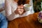 Young couple in a cafe in the attic drinking coffee and tea, sitting. Morning breakfast at the hotel. Cropped image of couple in l