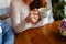 Young couple in a cafe in the attic drinking coffee and tea, sitting. Morning breakfast at the hotel. Cropped image of couple in l