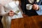 Young couple in a cafe in the attic drinking coffee and tea, sitting. Morning breakfast at the hotel. Cropped image of couple in l