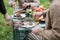 A young couple celebrates their wedding anniversary on a country plot. They roast meat, drink beer, relax in nature.