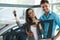 Young Couple Celebrating Purchase of a car In Car Showroom