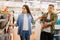 Young couple choosing plates in houseware store