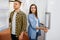 Young couple choosing refrigerator in store