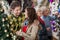 Young Couple In Christmas Store With Parents In