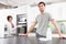 Young Couple Cleaning Modern Kitchen