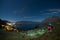 Young couple climbs up a hill to look at Queenstown, New Zealand at night