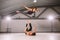 Young couple Couple practicing acro yoga in gym. Healthy lifestyle. Acroyoga. Couple yoga. Partner yoga. Muscular man throwing