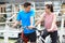 Young Couple Cycling Next To River In Urban Setting