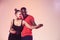 Young couple dances social Caribbean Salsa, studio shot