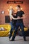 Young couple dancing latin music: Bachata, merengue, salsa. Two elegance pose on cafe with brick walls
