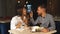 Young couple on a date. A man feeds his woman a delicious dessert. Couple laughing in the restaurant