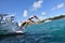 Young couple diving in the sea jumping from boat