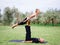 Young couple doing acro bird yoga pose. Healthy lifestyle modern activity.