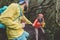 Young couple doing forest excursion - Happy people having fun discovering nature woods