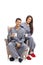 Young couple dressed in pajamas sitting in an armchair and holding cups