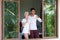 Young Couple Drink Coffee Or Tea, Man And Woman Awake Enjoy Tropical Forest View From Bedroom