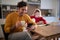 A young couple drinking coffee and surfing the internet at the kitchen. Routine, relationship, together