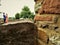 Young couple embraces amid ruins of old stone farmhouse