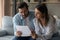 Young couple engaged in reading loan contract think on signing